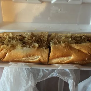 a hot dog in a styrofoam container