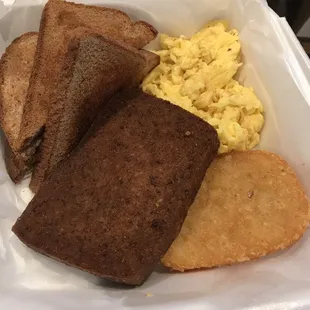 Scrapple, scrambled eggs, hash brown patty and wheat toast