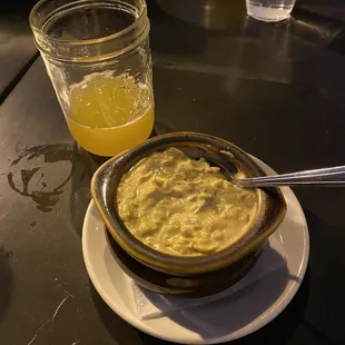 a bowl of oatmeal and a glass of orange juice