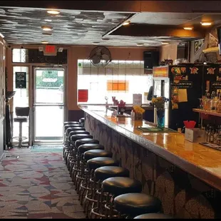 a long bar with stools