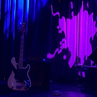 a stage with a guitar and a bass