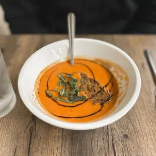 a bowl of soup and a glass of water