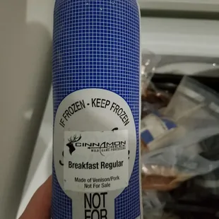 a hand holding a roll of food