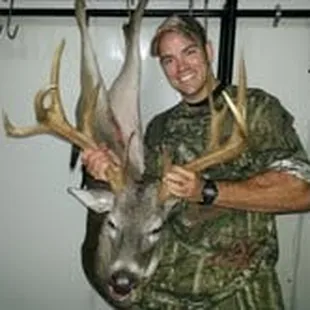 a man holding a deer