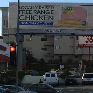 a large billboard on a street corner