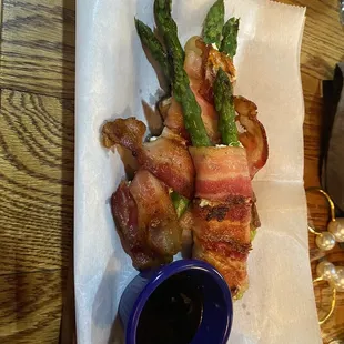 asparagus wrapped in bacon and served with dipping sauce