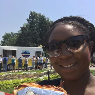 a woman holding a sandwich