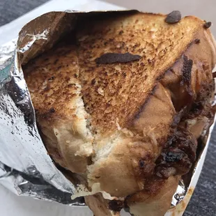 a grilled sandwich wrapped in aluminum foil