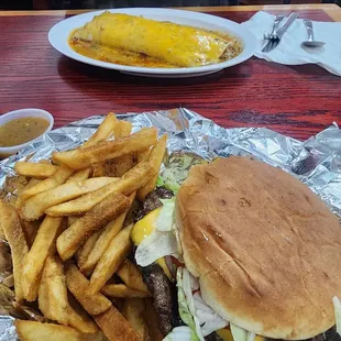 Front, burger basket lunch special with side of green chili sauce, must try! Back, beef and bean burrito covered in chili, its huge!