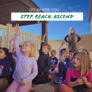 Child raising their hand in class.