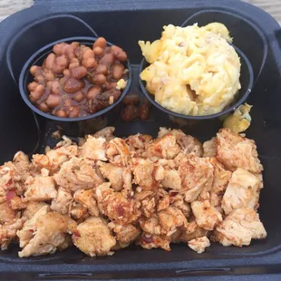 Chicken with a side of baked beans and jalepeno bacon Mac and cheese