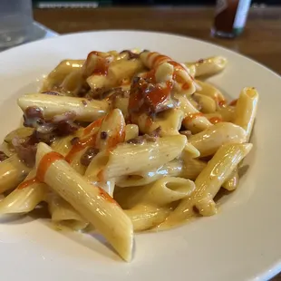 a plate of pasta with meat and sauce