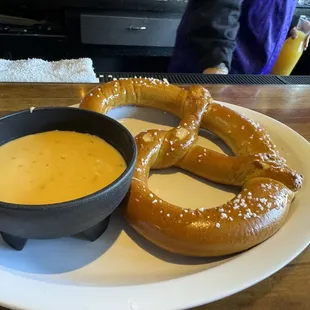 a pretzel and a bowl of soup