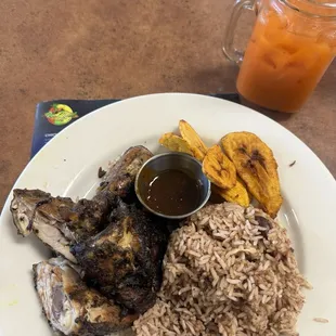 Jerk chicken with rice and peas, and fried plantains. Ginger carrot juice to wash it down.