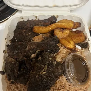 Jerk chicken plate over rice and plantains