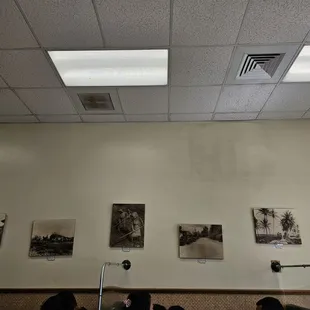 Wall decor above the booths where diners are enjoying their meals.