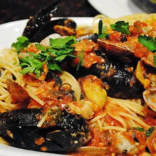 a plate of spaghetti with musselling and clams