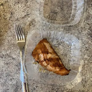 a half eaten piece of meat and a fork