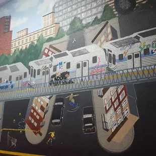 a mural on the wall of a subway station