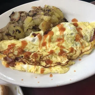 an omelet and potatoes on a plate