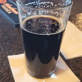 a glass of coffee on a coaster