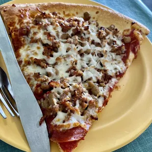 Meat lovers slice of pizza