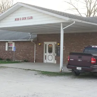 a pickup truck parked in front of the building