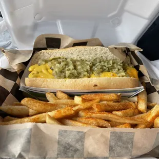 Hot dog with dill relish, nacho cheese, and mustard with seasoned fries