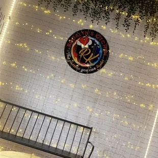 a white brick wall with a clock on it