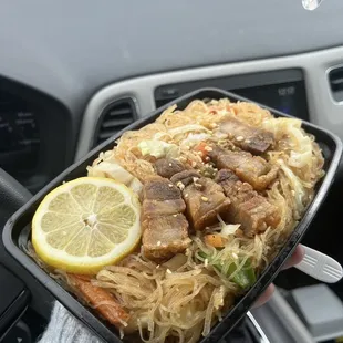 a person holding a tray of food