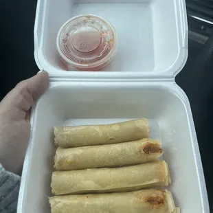 a person holding a container of food