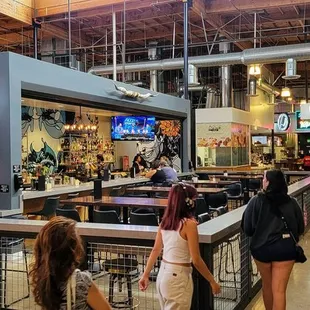 people walking around the bar
