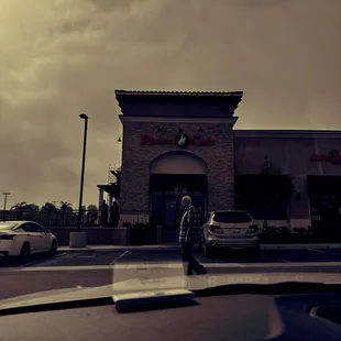 a man walking in front of a restaurant
