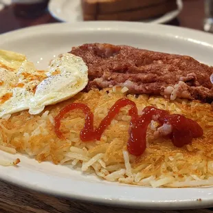 Two eggs over easy, hash brown, and corn Beef Hash