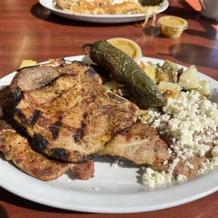 Pork chops with beans and potatoes.