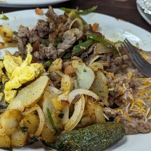 Steak fajitas with mushrooms onions bell peppers eggs ,beans and the best potatos you will ever have