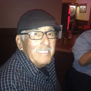 a man with glasses and a hat