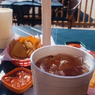 a drink and chips on a table