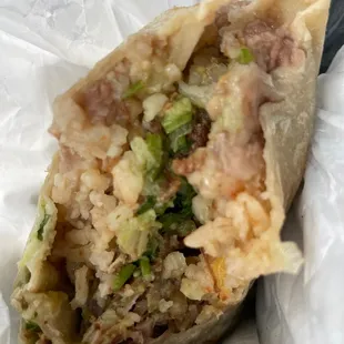 Inside carnitas burrito with everything rice, beans, onion, cilantro, salsa. So YUM!