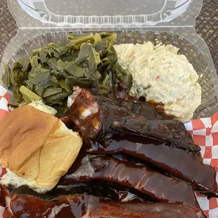 Rib dinner comes with 2 sides: collard greens and potato salad shown here, plus a Hawaiian roll