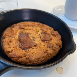 a chocolate chip cookie in a cast iron skillet