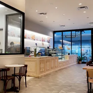 the interior of a restaurant with tables and chairs