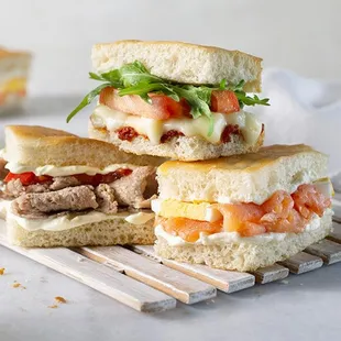 a stack of sandwiches with meat and cheese