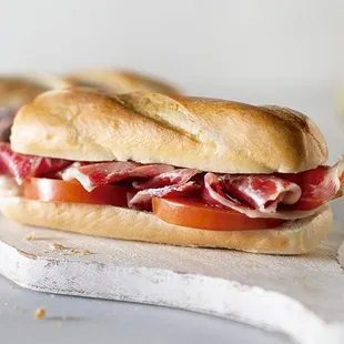 a sub sandwich on a cutting board