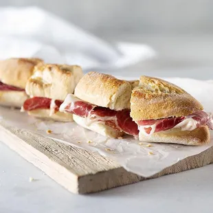 two sandwiches on a cutting board