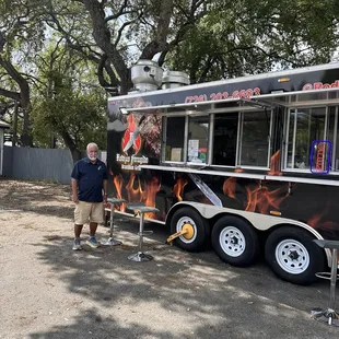 Standing on front of the food trailer at the ordering section