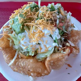 My taco salad. It came loaded with sour cream and guacamole, with plenty of onions. I ate it all!