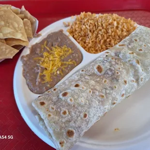 Chicken burrito with side of rice and beans