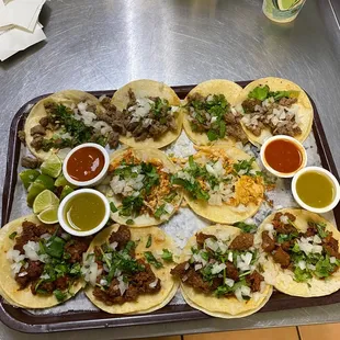 a platter of tacos and condiments