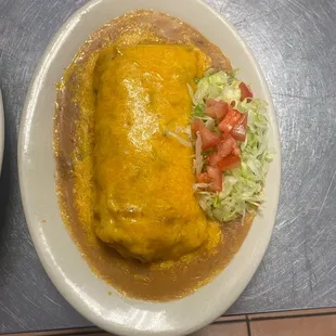 Bacon breakfast burrito smothered in delicious hot green chili.